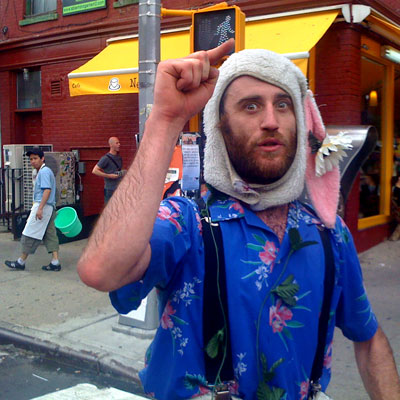 Returning from the crafts fair I came across several street performers with English accents. However they were fleeing north, so to engage this chap I accused him of being a hipster and managed to capture this image. - williamsburg brooklyn 11211